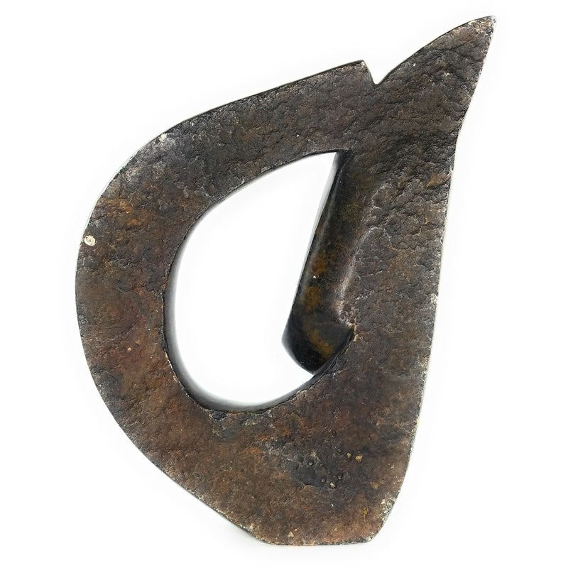 A brown, abstract-shaped stone sculpture of a face.