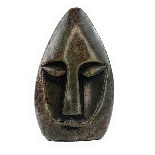 A hand-carved stone sculpture of an abstract face, with a dark, mottled appearance, indicative of the Shona art style.