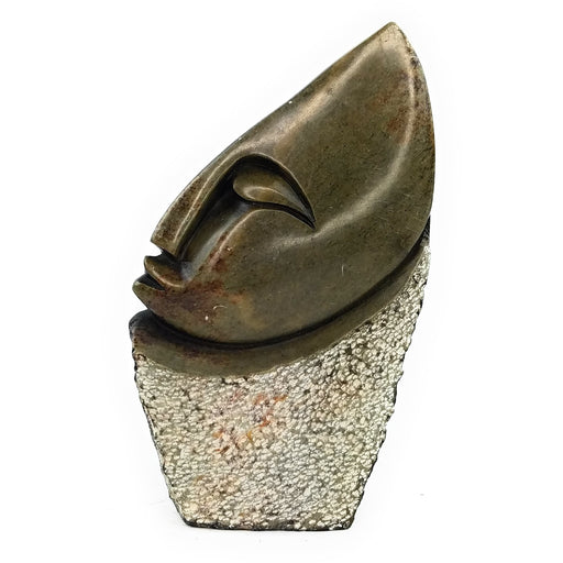A Shona stone sculpture of an abstract face, with a textured bronze-like finish.