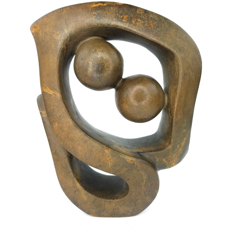 A bronze-colored, abstract sculpture of a kissing couple, handcrafted by Shona artisans in Zimbabwe.