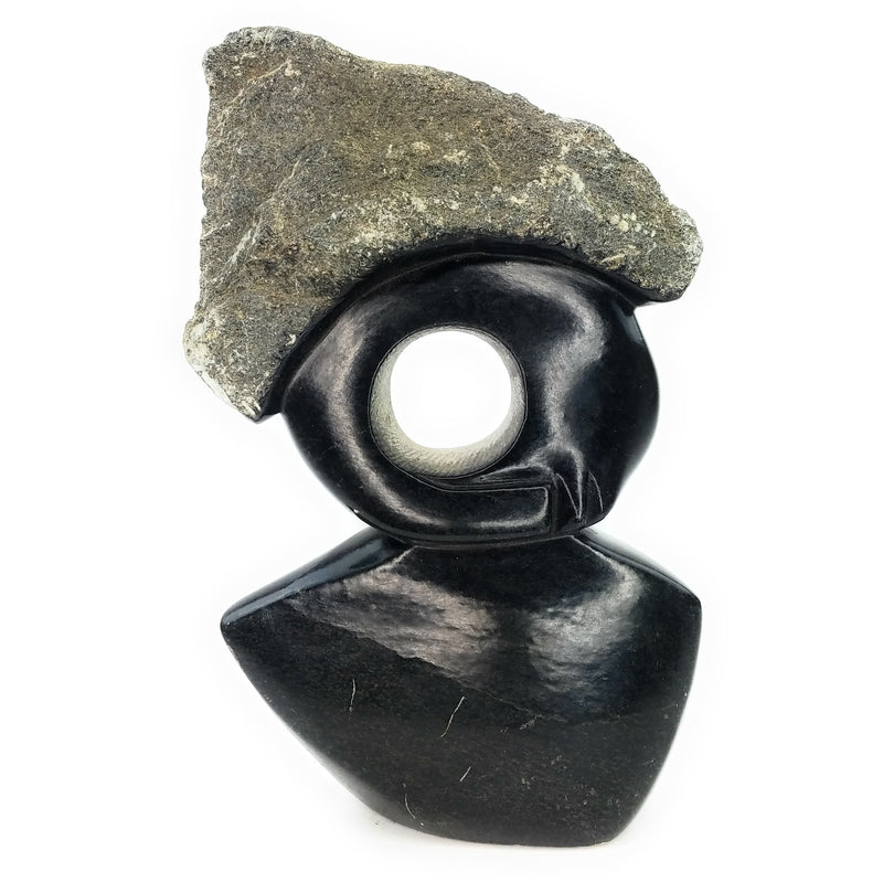 A black stone sculpture of an abstract lady, hand-carved in Zimbabwe.