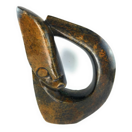 A brown, abstract-shaped stone sculpture of a face.