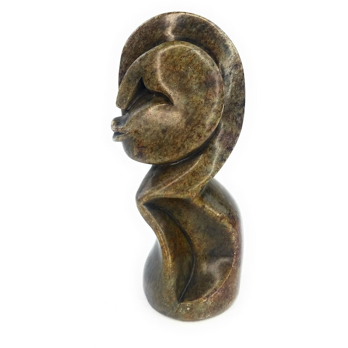 A hand-carved stone sculpture of an abstract woman's figure with elongated features, primarily in brown tones.