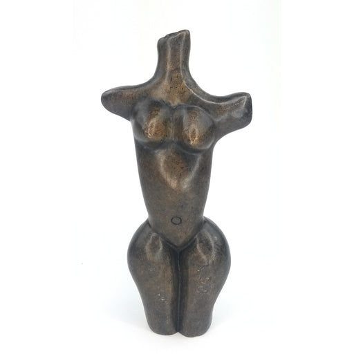 A handcrafted stone sculpture of a female torso, with exaggerated hips and breasts, representing the fertility of Mother Earth.