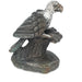 A serpentine sculpture of an African fish eagle perched on a tree with a fish, handcrafted by Shona artisans in Zimbabwe.