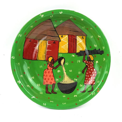 A decorative painted plate featuring a village setting with two figures and a thatched roof hut.