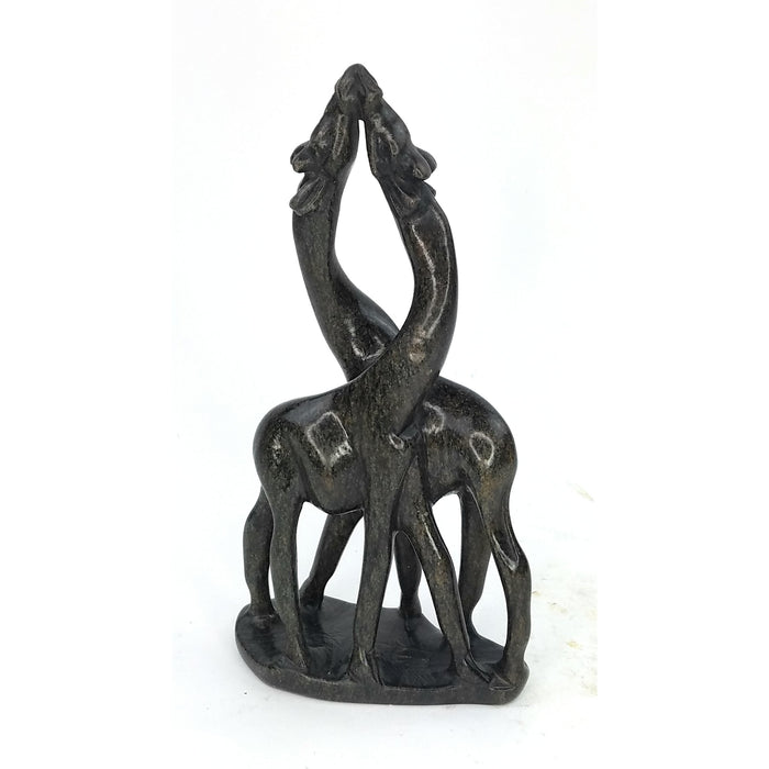 A serpentine stone sculpture of two giraffes in an embrace, hand-carved by Shona artisans in Zimbabwe.