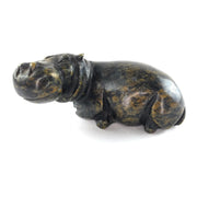 A hand-carved serpentine stone sculpture of a hippo, with a textured dark green finish.