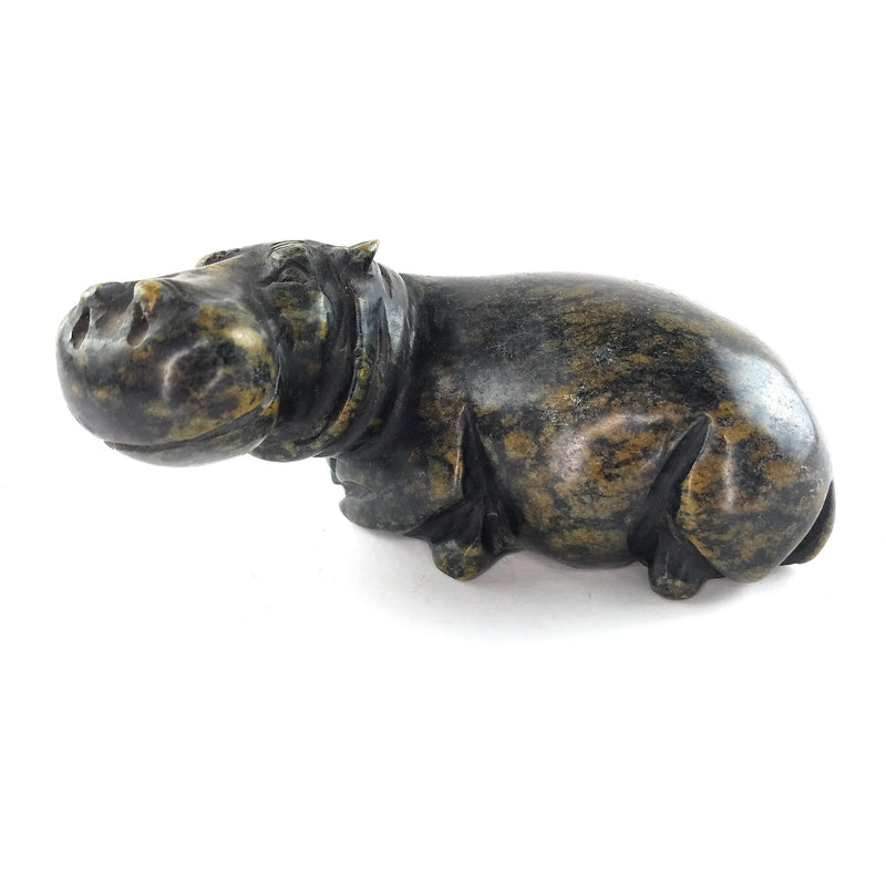A hand-carved serpentine stone sculpture of a hippo, with a textured dark green finish.