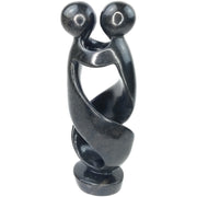 A hand-carved stone sculpture of a dancing couple, black serpentine material, from Zimbabwe.