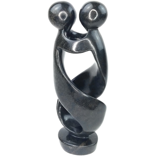 A hand-carved stone sculpture of a dancing couple, black serpentine material, from Zimbabwe.