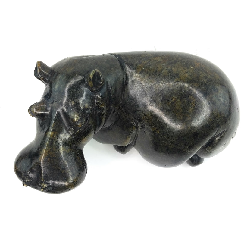 A hand-carved stone sculpture of a hippo, with a textured dark finish.