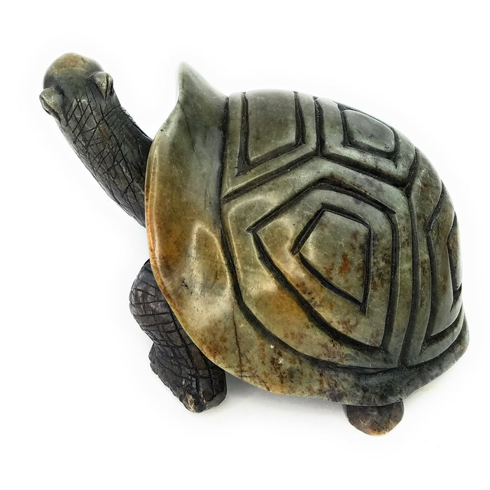 A hand-carved stone turtle sculpture in various shades of green and brown.