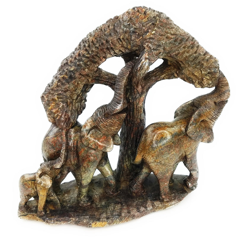 A hand-carved stone statue featuring an elephant and its calf, with a tree in the background, indicating a natural and rustic theme.