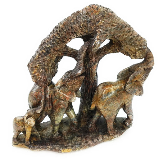 A hand-carved stone statue featuring an elephant and its calf, with a tree in the background, indicating a natural and rustic theme.