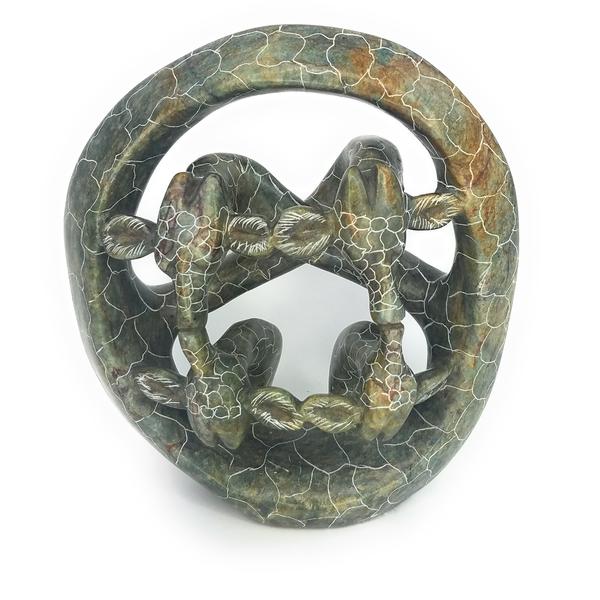 A hand-carved serpentine stone sculpture of a giraffe family, with intricate patterns and a mottled green finish.