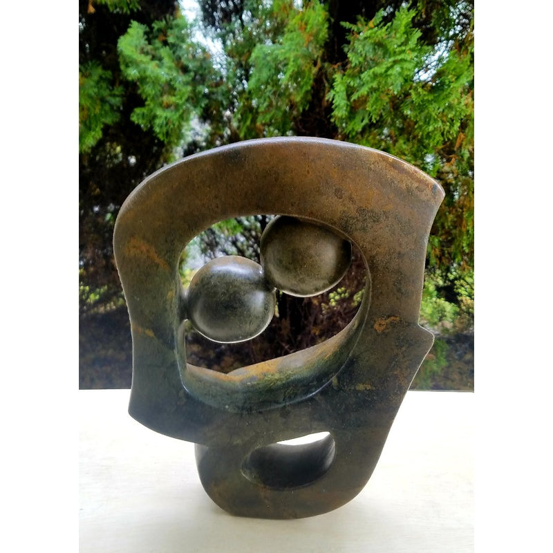 Hand-carved Abstract Kissing Couple sculpture by Shona artisans in Zimbabwe.