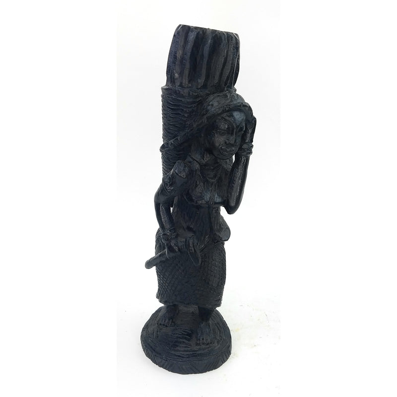A black sculpture of a hardworking woman statue, handmade in Tanzania, with intricate details and a textured surface.