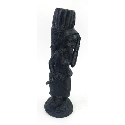 A black sculpture of a hardworking woman statue, handmade in Tanzania, with intricate details and a textured surface.
