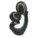 A hand-carved stone sculpture of a kissing couple, primarily in dark tones, against a white background.