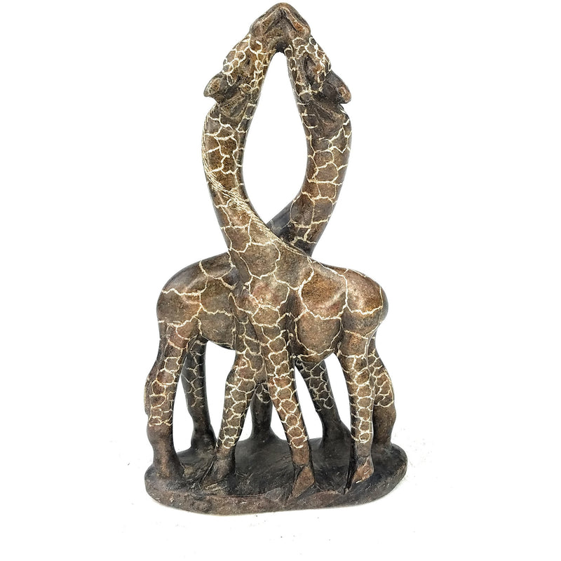 A hand-carved stone sculpture of two giraffes in an embrace, brown in color, against a white background.
