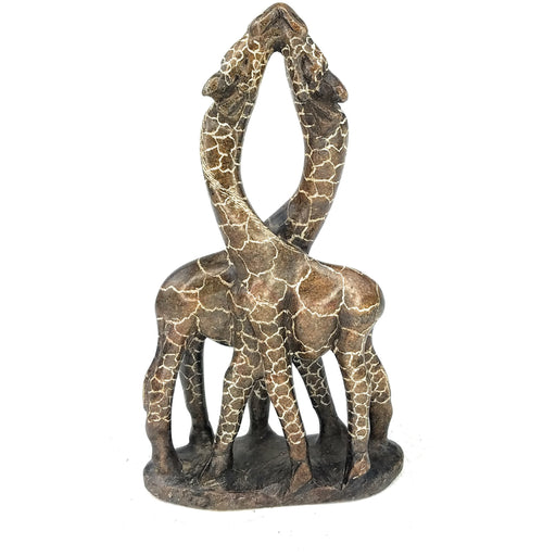 A hand-carved stone sculpture of two giraffes in an embrace, brown in color, against a white background.