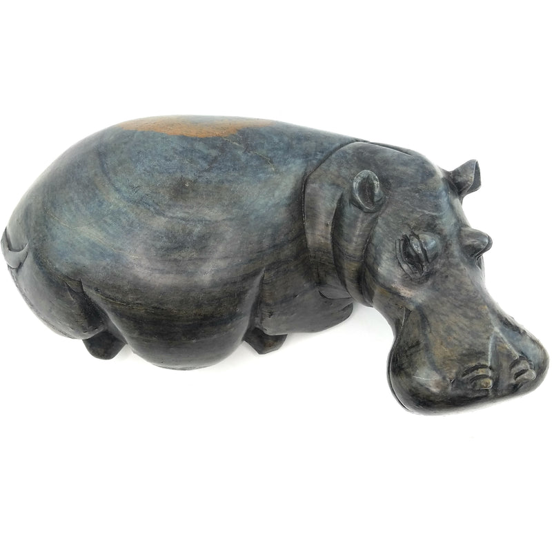 A hand-carved serpentine stone sculpture of a hippo, with a dark, textured finish.