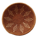 A handwoven Lutsindzi grass basket from Swaziland, with a natural brown color and geometric pattern design.