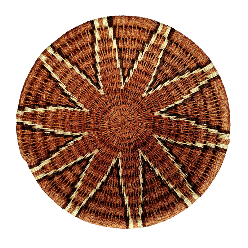 A hand-woven Lutsindzi grass basket from Swaziland, with a geometric pattern in brown and beige tones.