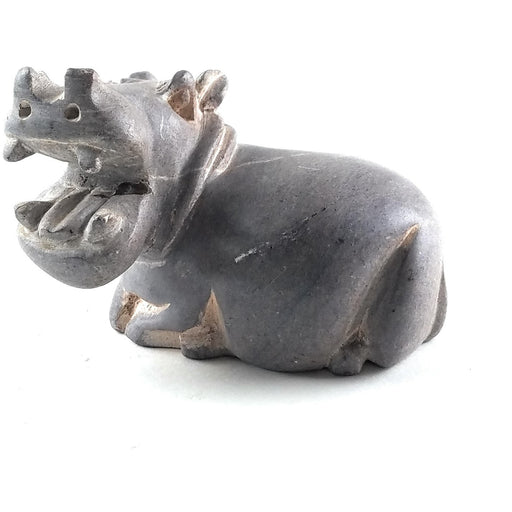 A hand-carved stone sculpture of a hippo, with a gray serpentine material, showing the animal's mouth open in a roar, indicative of the Shona art style from Zimbabwe.