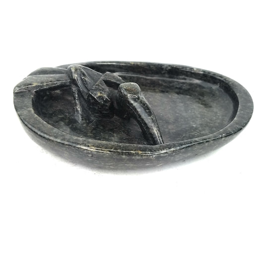 A serpentine stone soap dish with a floating pelican bird design, handcrafted in Zimbabwe.