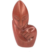 A red jasper stone sculpture of an abstract person's figure, handcrafted in Zimbabwe.