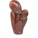 A hand-carved red stone sculpture of a mother and child, with a focus on the mother embracing her child.