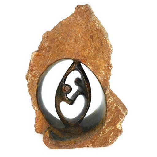 A hand-carved stone sculpture depicting a couple in an eternal embrace, symbolizing love.