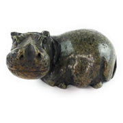 A hand-carved serpentine stone sculpture of a hippo, with a naturalistic and rustic finish.