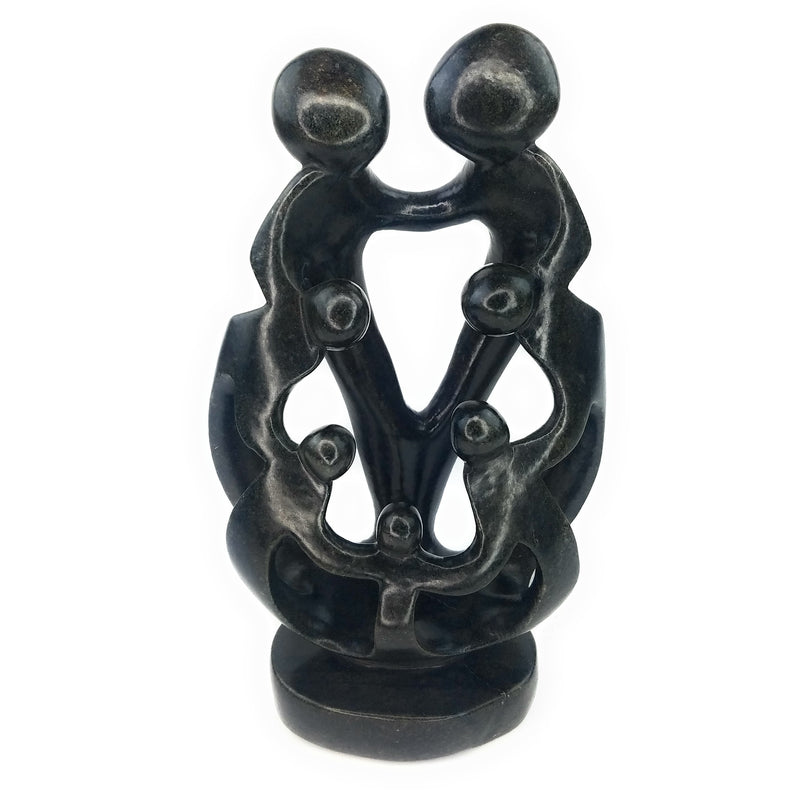 A hand-carved stone sculpture depicting a family of seven, with a mother, father, and five children, in black.