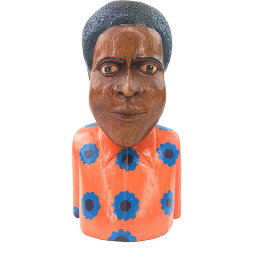 A wooden bust figurine with a realistic face and body, primarily orange with blue and black floral patterns, and a patterned orange shirt.
