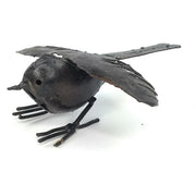 A black recycled metal bird sculpture with outstretched wings, handcrafted and varnished, posed with a slightly open mouth.