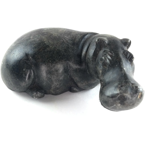A hand-carved stone sculpture of a hippo, with a dark serpentine finish.