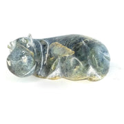 A hand-carved serpentine stone sculpture of a hippo, with a rough, textured surface and no additional coloration beyond the natural stone tones.
