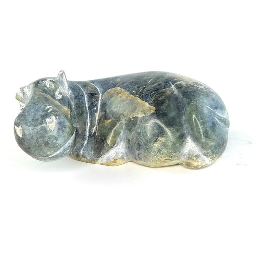 A hand-carved serpentine stone sculpture of a hippo, with a rough, textured surface and no additional coloration beyond the natural stone tones.