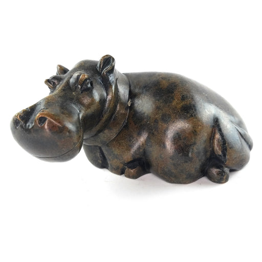 A hand-carved serpentine stone sculpture of a hippo, with a textured dark finish.