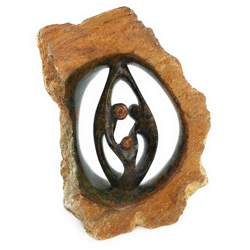 A hand-carved stone sculpture depicting a family of three, made from rapoko stone, with a natural patina.