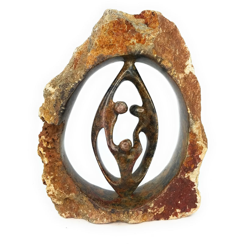 A hand-carved stone sculpture depicting a family of three, with intricate details and a rustic finish.