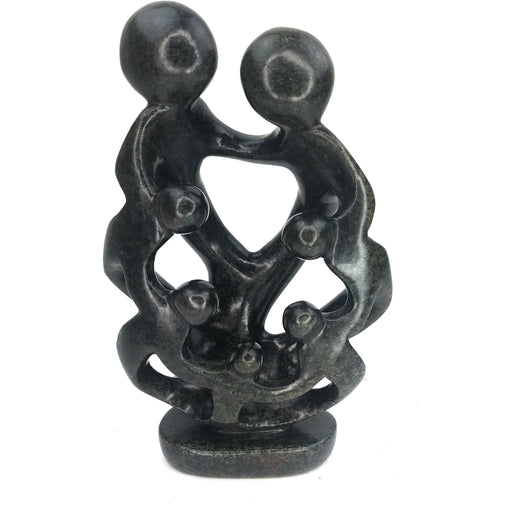 A hand-carved sculpture depicting a family of seven with interlinked arms, made from the dark serpentine stone.