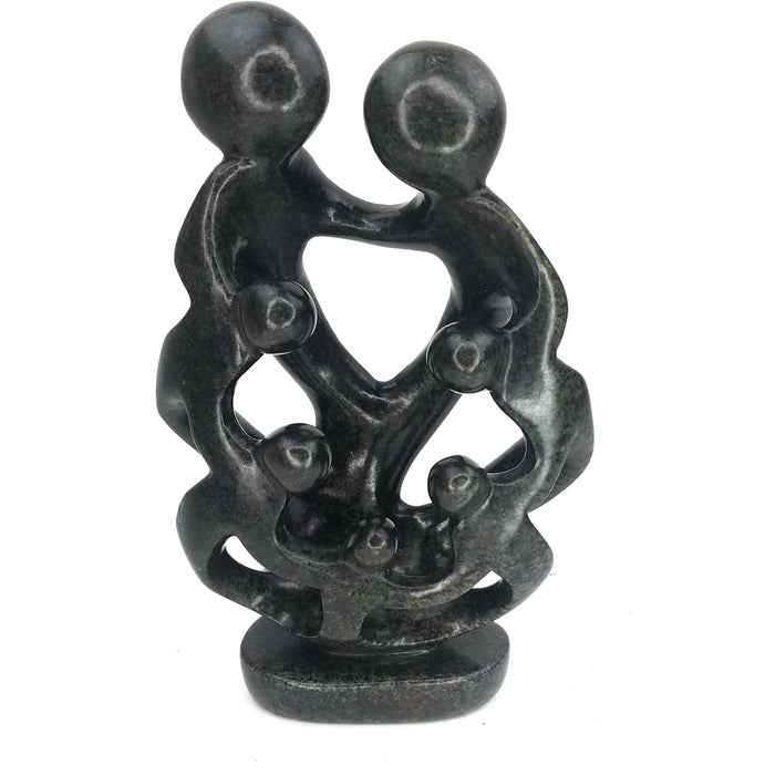 A hand-carved sculpture depicting a family of seven with interlinked arms, made from the dark serpentine stone.