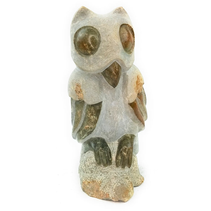 A hand-carved stone owl sculpture, primarily in shades of grey and beige, with a textured surface indicating its handcrafted nature.