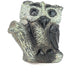A hand-carved stone sculpture of an owl with intricate detailing and a textured surface, primarily in dark tones.
